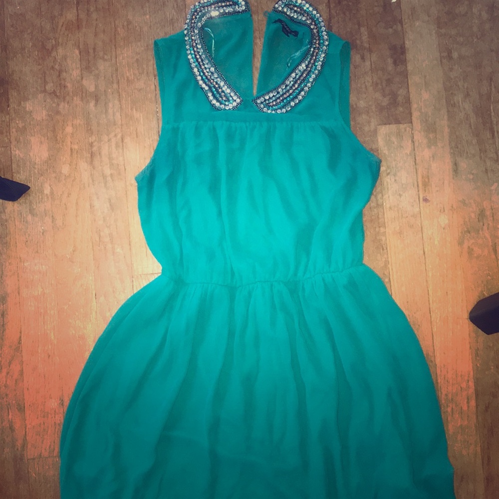 Green sleeveless dress with bejeweled collar